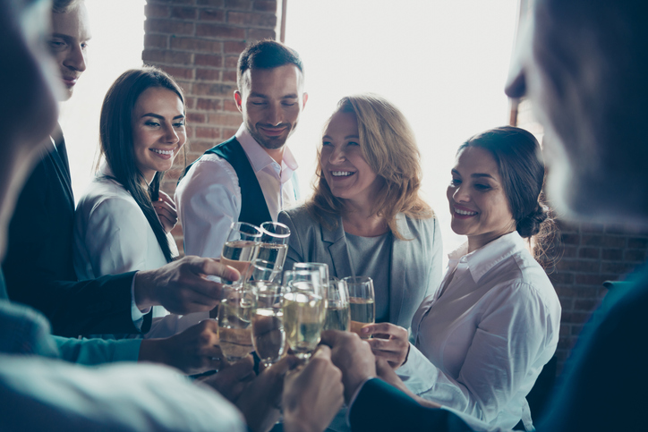 Close up photo of big company of people having rest drinking champagne, glad to have christmas holidays cheers all dressed in formal wear jackets shirts suits